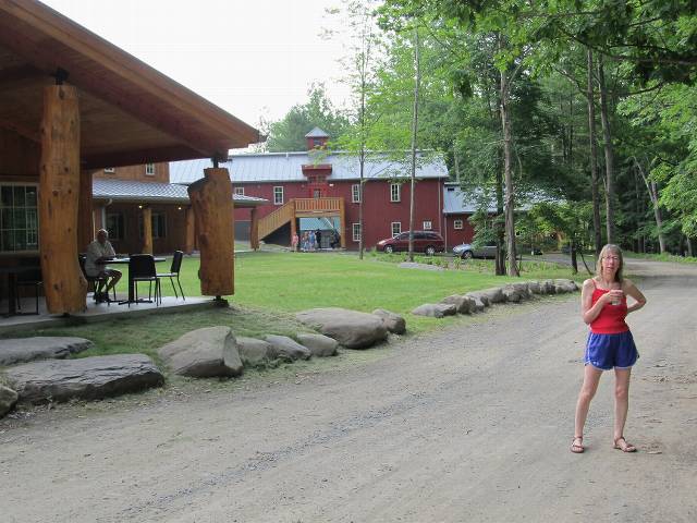 Kathy with the new camp buildings.  Porches everywhere!